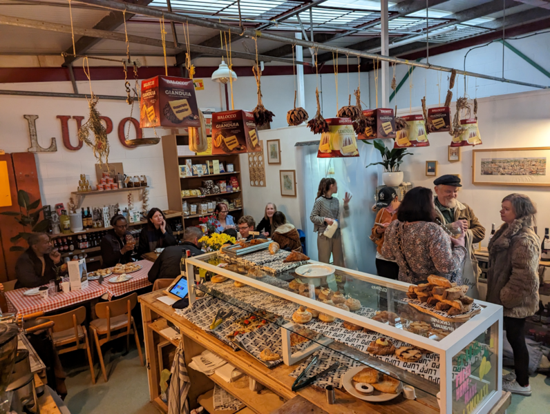 Lupo, Prestwich, Greater Manchester — lively Italian café with communal tables, hanging panettone, bakery counter and shelves of deli goods — North West & Yorkshire regional winner, Best Local Restaurant 2025 in The Good Food Guide.